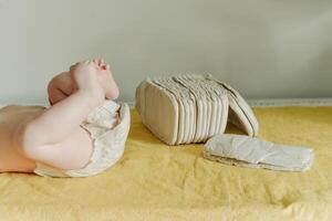 Baby wearing a white reusable nappy photo
