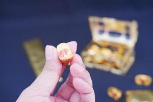 golden box with chocolate on a black background. photo