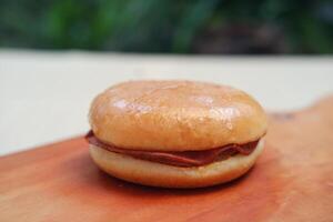 Sandwich with ham and cheese on wooden board. Selective focus. photo