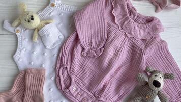 Set of pink clothes and accessories for newborn baby. video