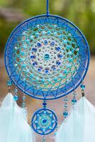 Handmade dream catcher with feathers threads and beads rope hanging photo