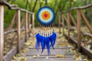 Handmade dream catcher with feathers threads and beads rope hanging photo