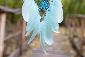 Handmade dream catcher with feathers threads and beads rope hanging photo