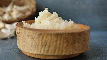close up of minced garlic on a wooden bowl video
