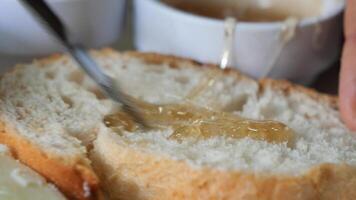 close up of fresh honey spread on a bread video