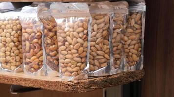 many mixed nuts in a plastic packet on shelf video