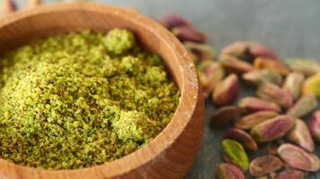 Wooden bowl filled with pistachios powder video