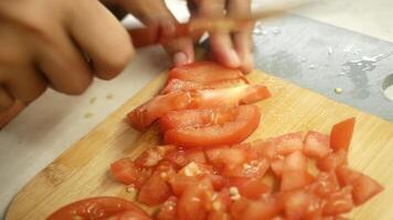 cutting fresh tomato on a chopping board video