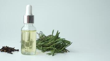 eucalyptus essential oils in a glass bottle with green leaf on white background video