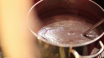 cocoa is boiled in a metal pot, making hot chocolate video
