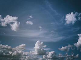 White cumulus clouds in the blue sky. Aesthetics of vintage film. photo