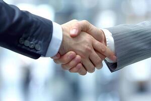 Business people shaking hands after good deal photo