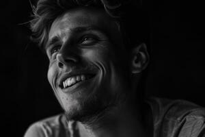 monocromo retrato de joven sonriente caucásico hombre en negro antecedentes foto