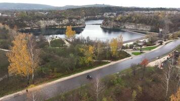 Autumn Serenity at Quarry Lake Park, Tranquil quarry lake with autumn foliage and walking paths. video