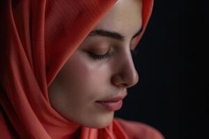 A Muslim woman with closed eyes on a black background. Arab girl in hijab in profile. photo