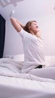 morning routines. Woman stretching in bed after wake up video