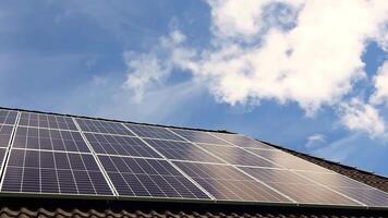 Solar panels producing clean energy on a roof of a residential house video