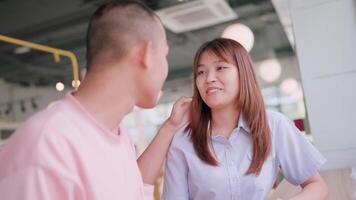 Close-up of a couple spending time together in a coffee shop. Happy couple sitting at wooden table talking and smiling at each other on romantic day. video