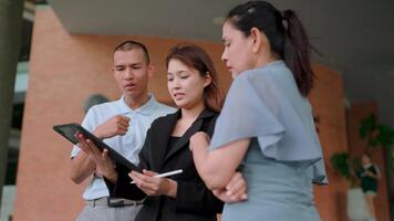 Coworkers in suits meet in office using digital tablet. Discuss online projects together Collaborate using modern equipment video