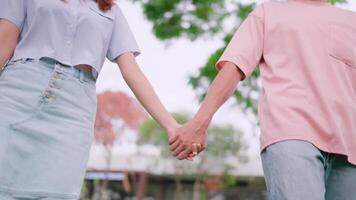 Close-up of a man looking back, trusting, holding hands, enjoying, relaxing, walking, forward into the sunlight. video