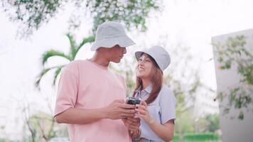 Couple looking at each other and talking after using smartphone to search information on mobile internet video