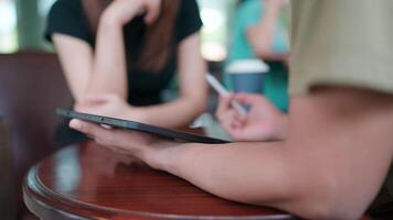 Close-up of a man presenting a project to a colleague using a tablet. video