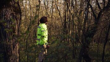 Rescue squad leader guiding route through the woods to collect evidence during searching operation to locate missing person. Shouting individual's name, civil disappeared in a forest. Camera B. video