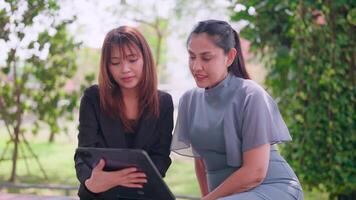 Confident Asian woman financial advisor explains advantages of deal Display presentations on the computer to focus on the customer. video