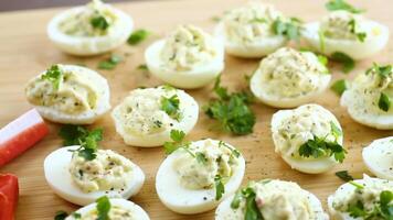 stuffed eggs, deviled eggs on a wooden table video