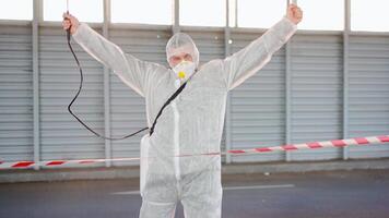 a person in a white suit with water spraying tools video