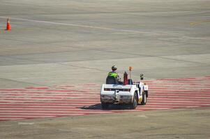 a towing tractor toyota being driven by airport officials on the apron of juanda international airport, Indonesia, 29 July 2023 photo