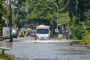 Dump truck crashing through floodwater in Gresik Regency, Indonesia, 21 February 2024. photo