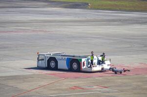 a pushback car or towing tracktor belonging to Angkasa Pura which is being operated by officers at the Juanda International Airport in Surabaya, Indonesia, 29 July 2023.q photo