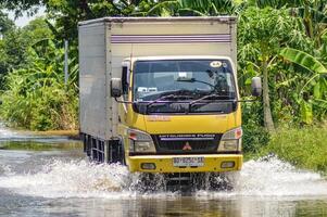 a logistics box truck passing through flood waters in Gresik district, Indonesia, 21 February 2024. photo