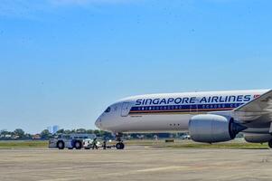 an Airbus A350 aircraft owned by Singapore Airline being pushed using a pushback car at Juanda International Airport, Surabaya, Indonesia, 29 July 2023 photo