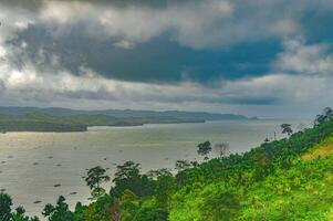 natural scenery of gemah beach and popoh bay facing the south sea of java island or indian ocean decorated with some mountains photo