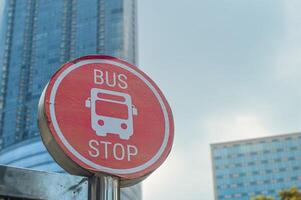 a bus stop sign for the Suroboyo bus or Trans Semanggi with an urban background photo