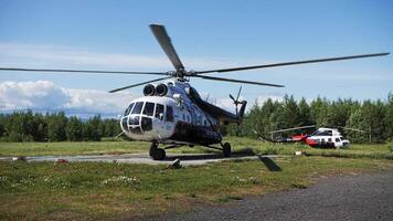 A Mi-8 helicopter with rotating propellers steers across the helipad video