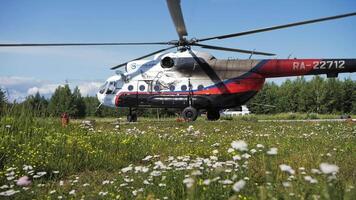 A Mi-8 helicopter with spinning propellers stands on the helipad video