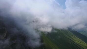 a aéreo Visão do uma montanha coberto dentro nuvens video