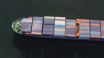 Aerial top-down view of a passing container ship with a cargo of containers video