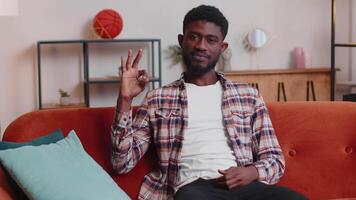 African american man showing ok gesture, like sign positive something good gives positive reply home video