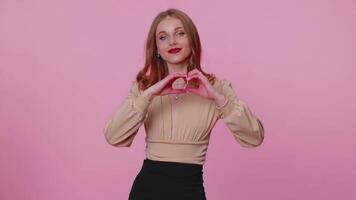 Smiling businesswoman girl makes sign heart shape gesture demonstrates love feelings, sympathy video