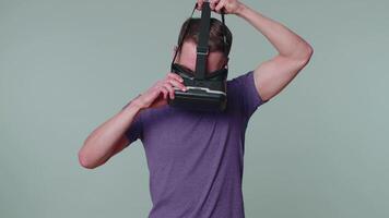 Man using virtual reality futuristic technology VR headset helmet to play simulation 3D game video