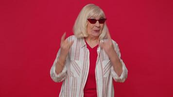 Overjoyed happy woman showing rock n roll gesture by hands, cool sign, shouting yeah with crazy face video