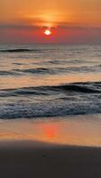 Vertikale Aufnahmen von Sonnenaufgang beim Strand mit Orange Himmel video