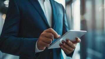 Close up businessman hand using tablet and pointing on summary report at office. Male businessman reviews a summary report on tablet. photo