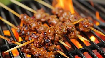 Close up of satay on barbecue photo