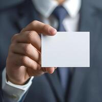 Close up hand of Businessman holding blank white card in studio photo