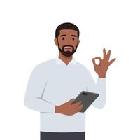 Young man Approved gesture, Ok sign with Smiling holding tablet. vector